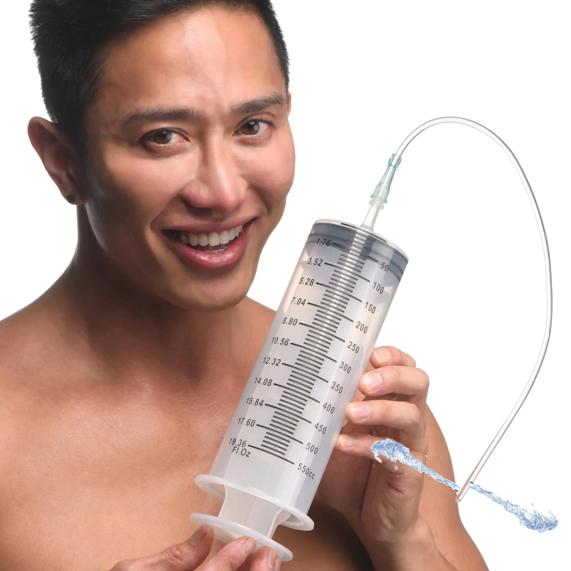 A man holds a large, translucent CleanStream Enema Syringe with measurement markings and a clear attached tube.