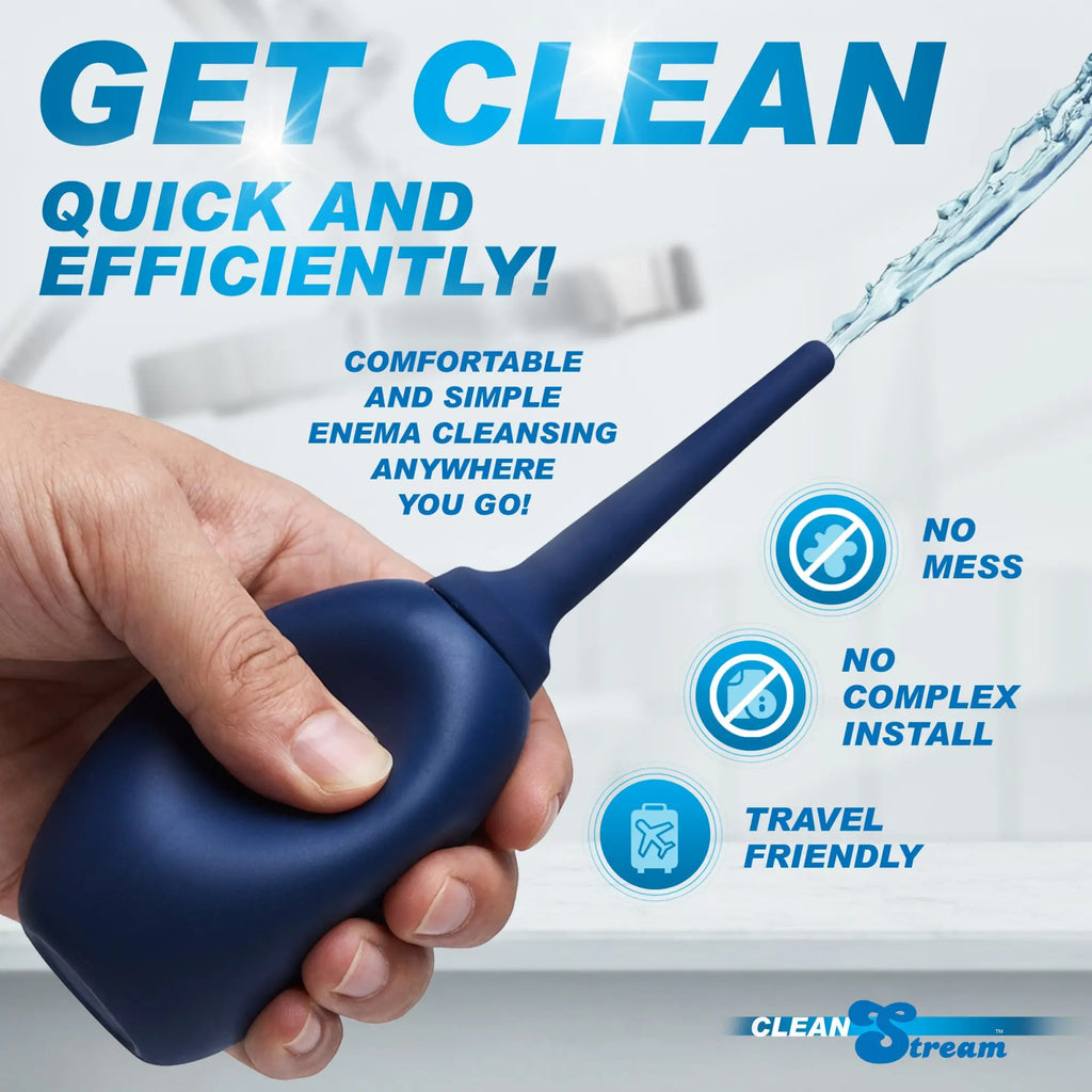 A hand holds a navy blue CleanStream Flex Tip Enema Bulb, which sprays water from its flexible nozzle.