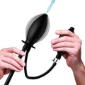 CleanStream Inflatable Enema Plug: Black pump and plug with hands demonstrating inflation and water flow.