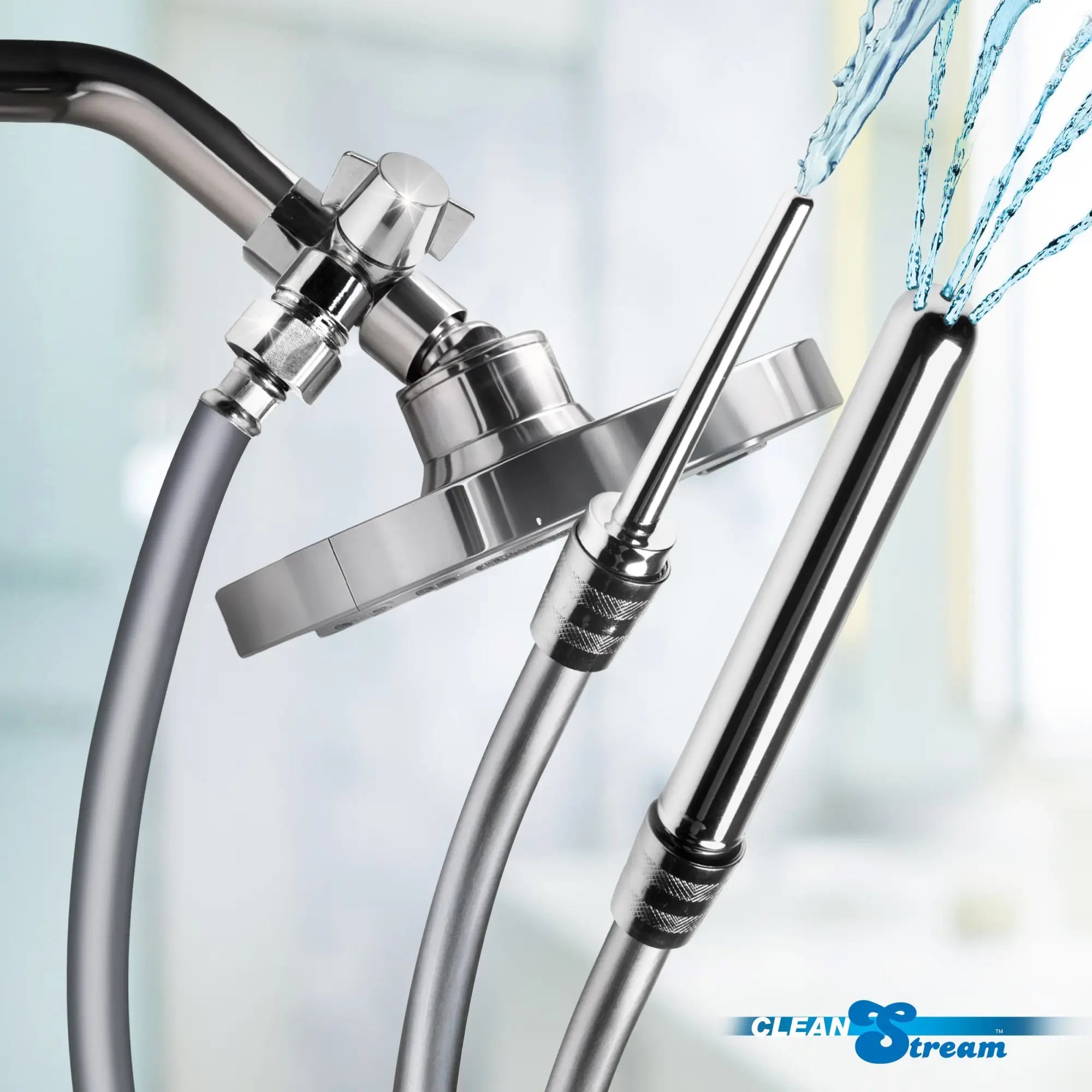 CleanStream Shower Enema Set: A chrome shower attachment with hoses spraying water from two metal nozzles.