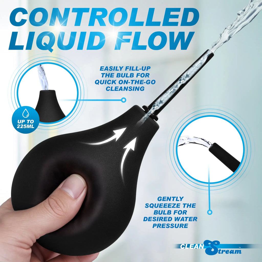 CleanStream Thin Tip Enema Bulb: A hand squeezing a black bulb to demonstrate water flow and pressure control.