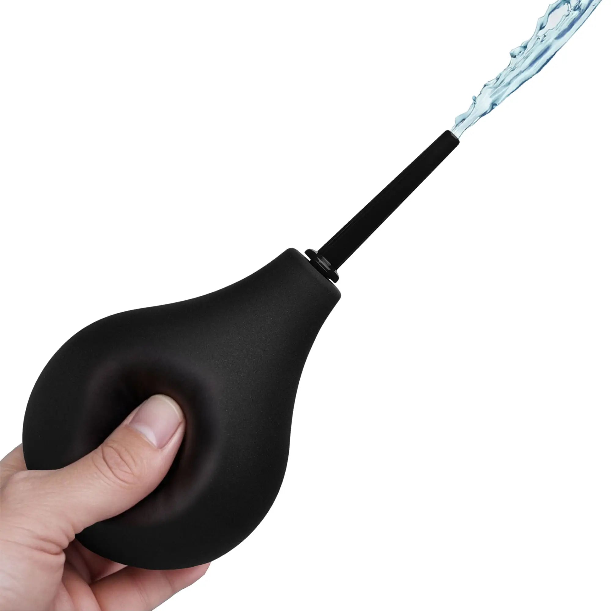 A hand squeezing a black CleanStream Thin Tip Enema Bulb, spraying a stream of water from the nozzle.