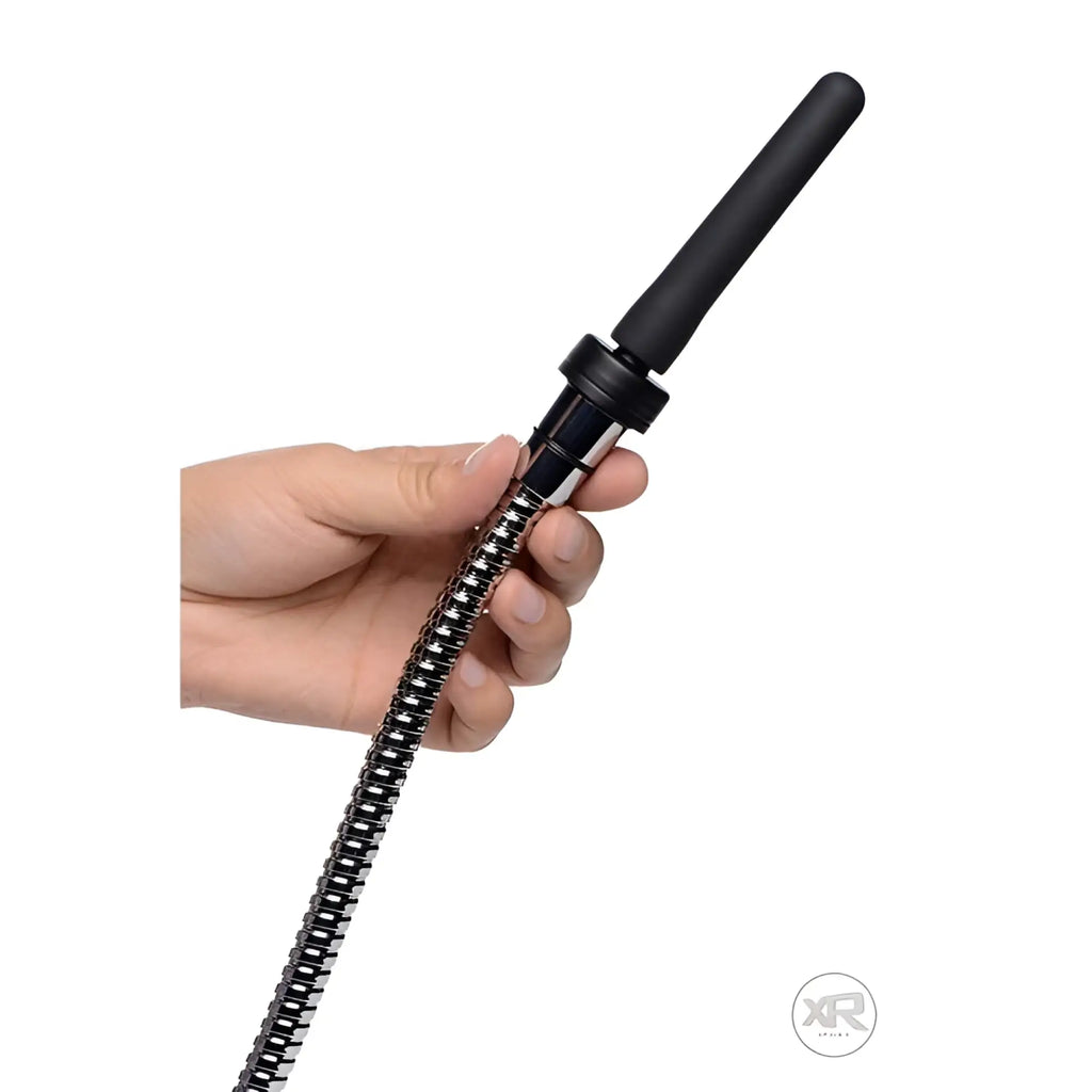 CleanStream Travel Enema adapter set featuring a flexible, coiled metal hose and a smooth black tip held in a hand.