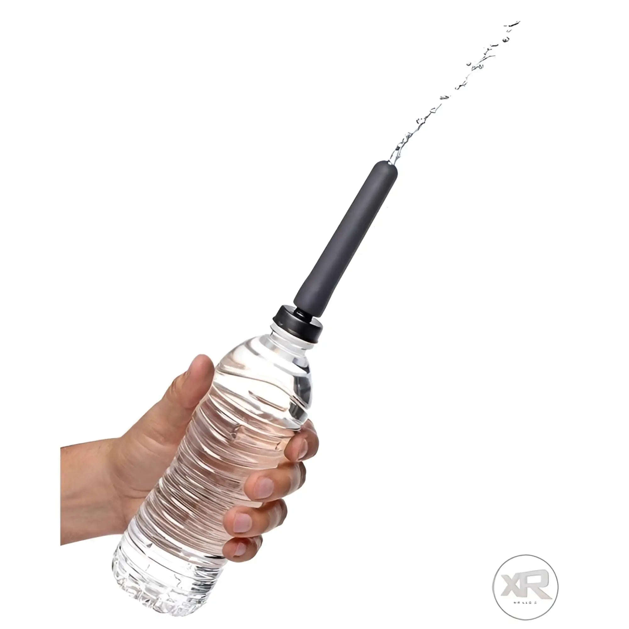 CleanStream Travel Enema adapter on a plastic water bottle, showing a steady stream of water spraying from the nozzle.