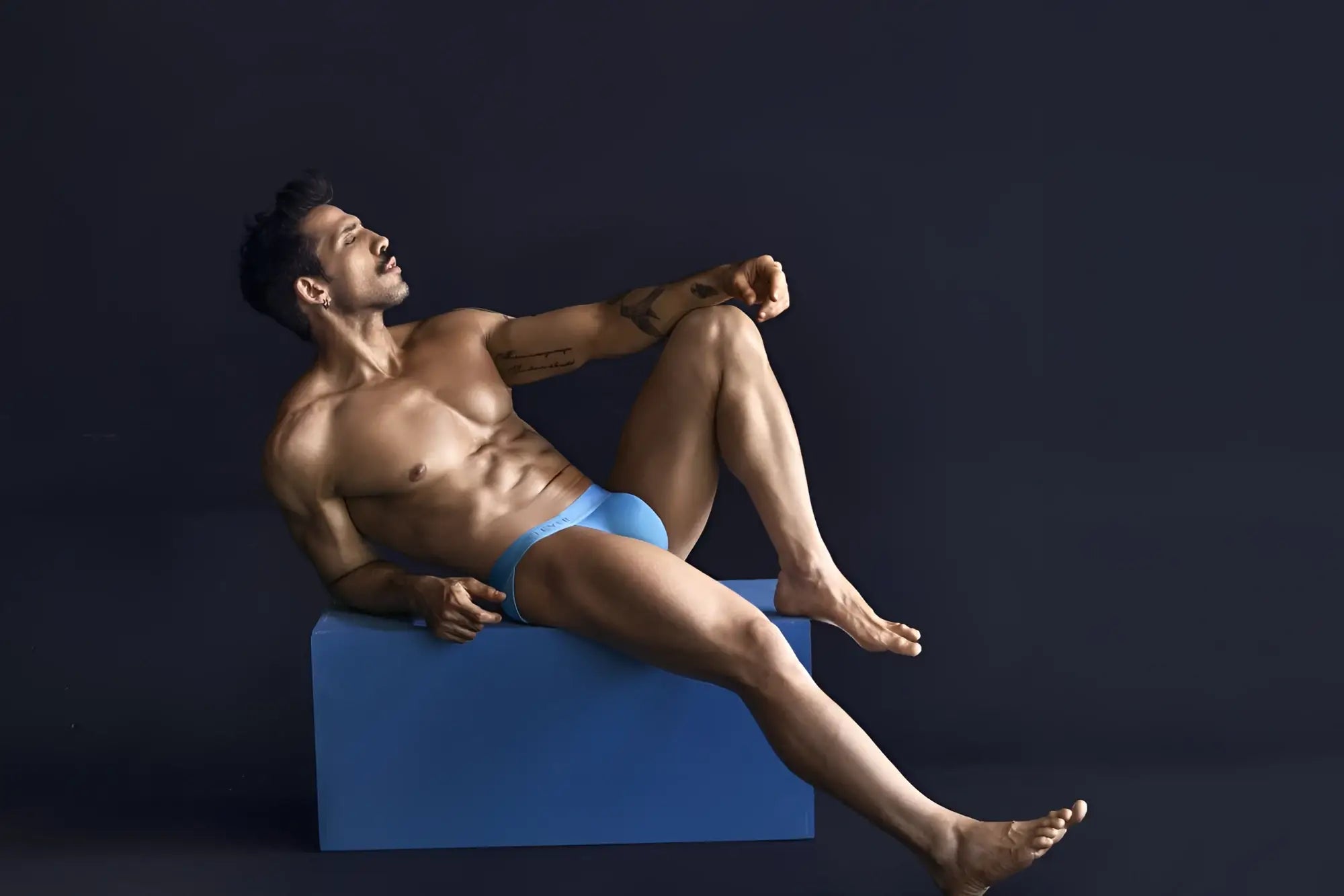 A man wearing bright blue eco-friendly Clever 1749 bikini briefs made from sustainable material front view