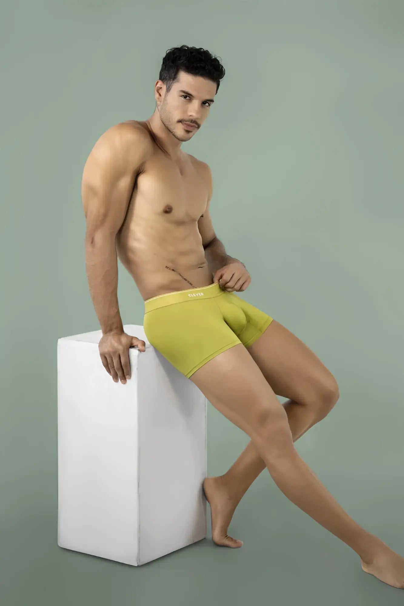 Clever 26008 Atenea green boxer briefs on a model sitting on a white cube.