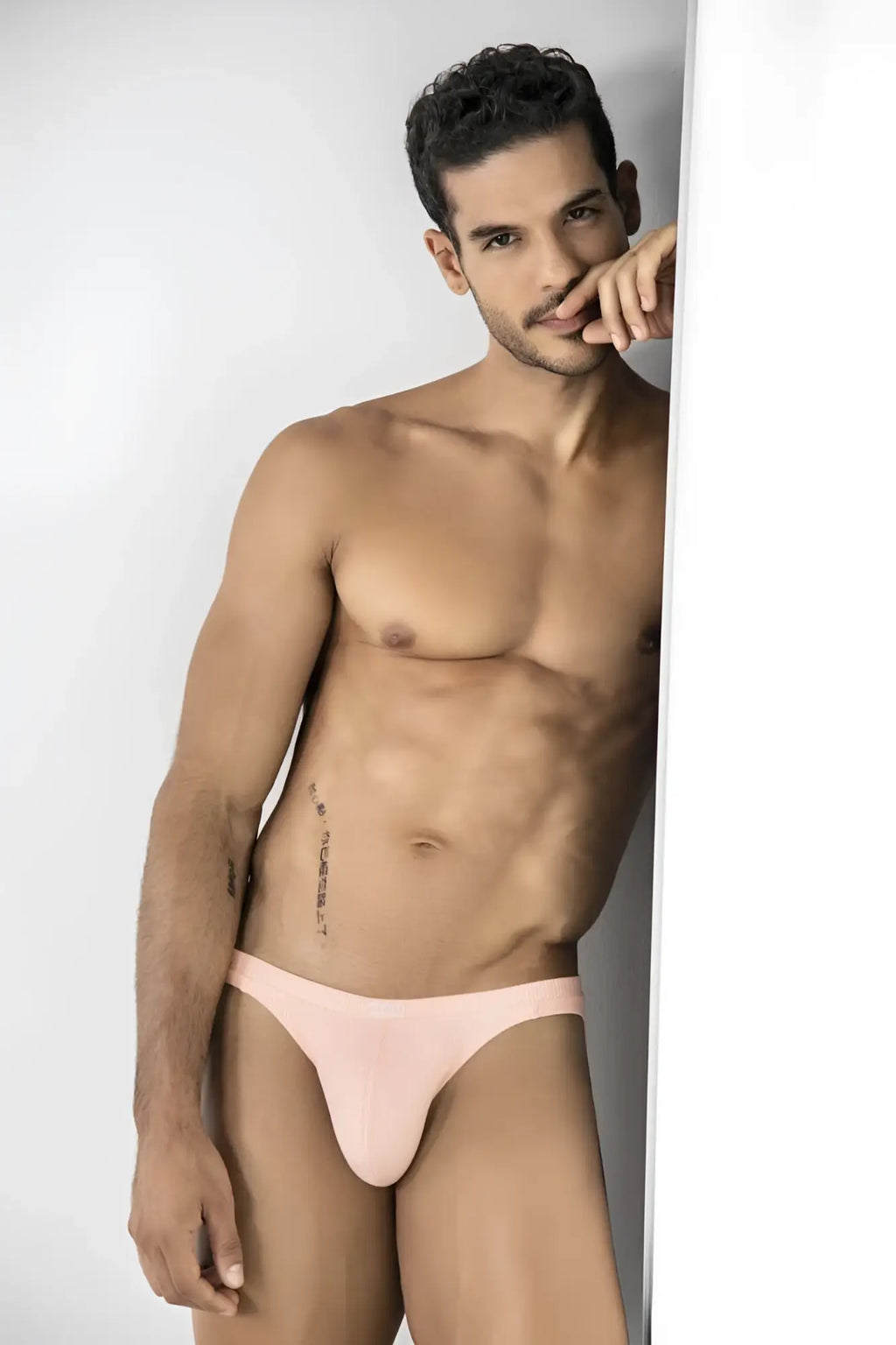 Model wears Clever 26020 Apolo thongs in a ribbed, pale orange fabric against a white background.