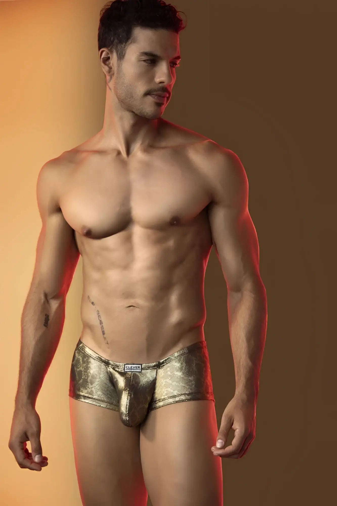 Clever 26042 Atlas trunks in metallic gold featuring a form-fitting design on a shirtless man.