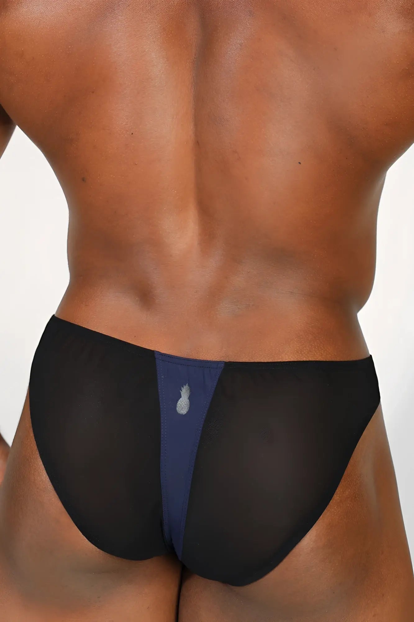 Club-Kid mesh bikini briefs in midnight blue with black mesh sides and a navy panel featuring a silver pineapple emblem