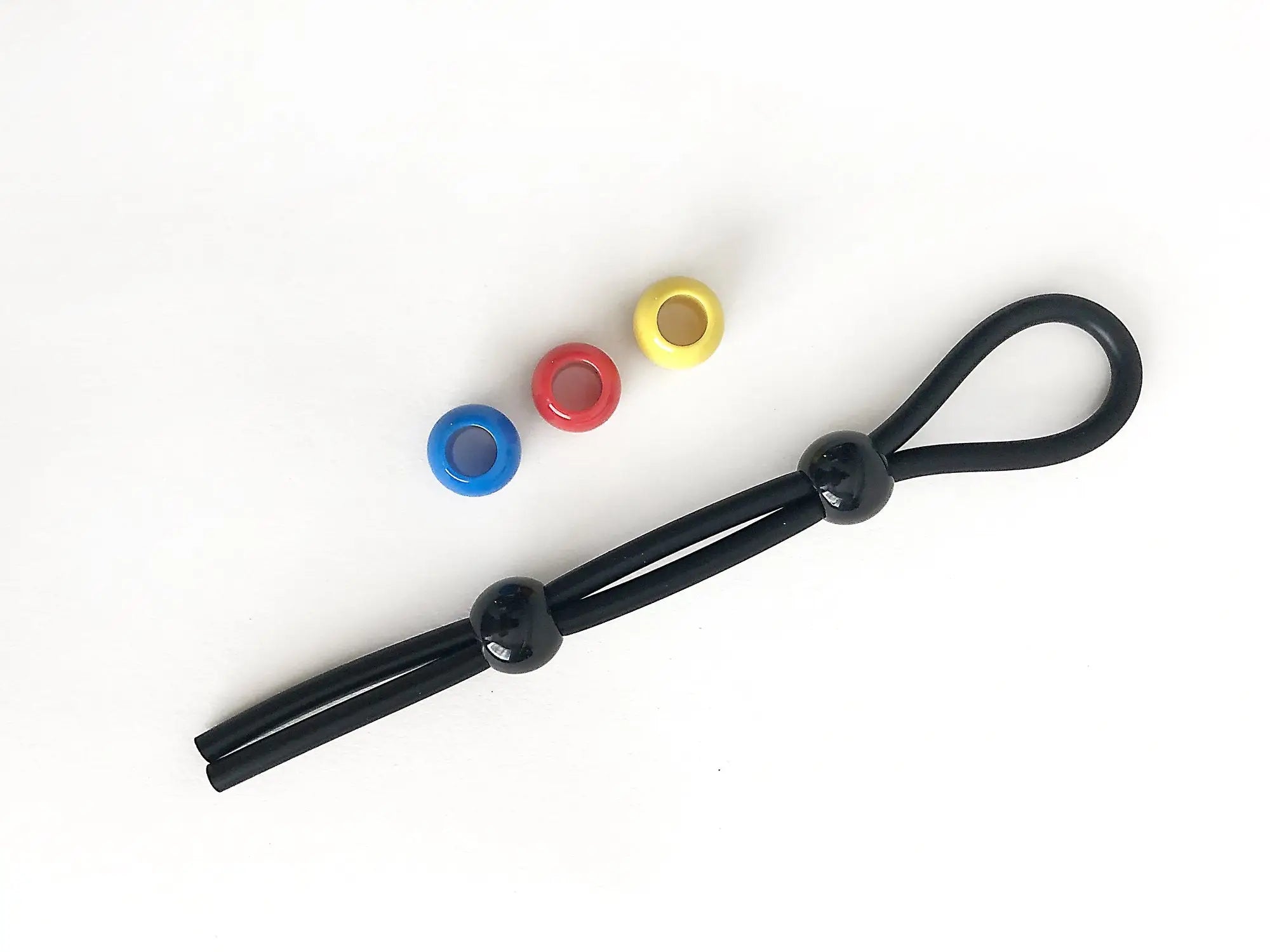 Black elastic cock leash double with glossy black beads and blue red yellow plastic rings for secure fit