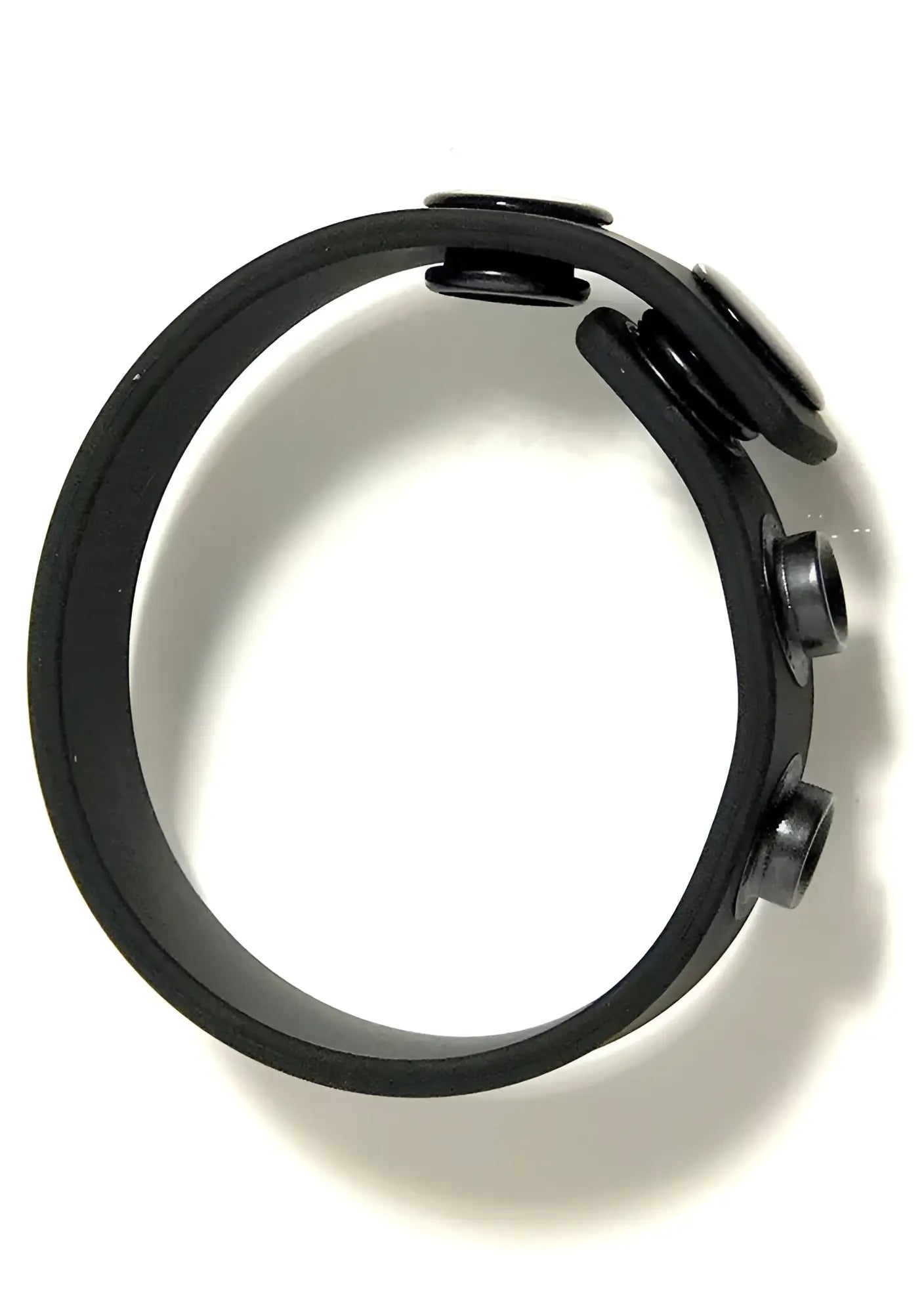 Black rubber cock strap wristband with three circular snap closures for adjustable fit and comfort