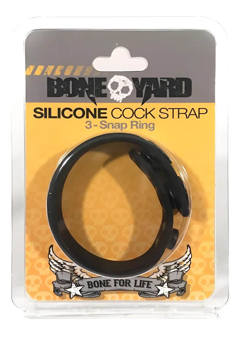 Black silicone cock strap with 3 snap ring design packaged in clear plastic with yellow and gray branding
