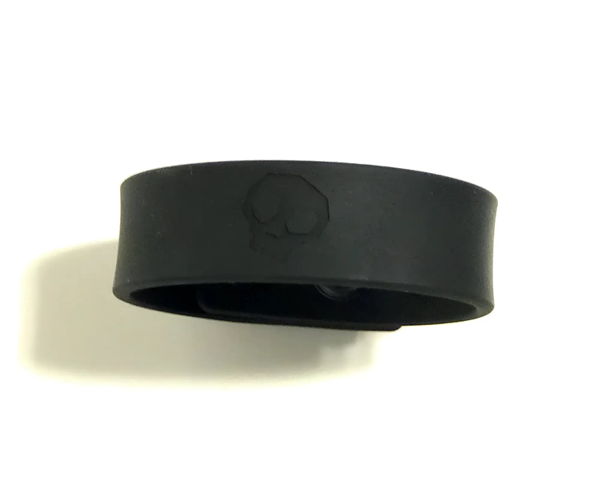 Black silicone cock strap wristband with a subtle embossed skull design for edgy style and comfort