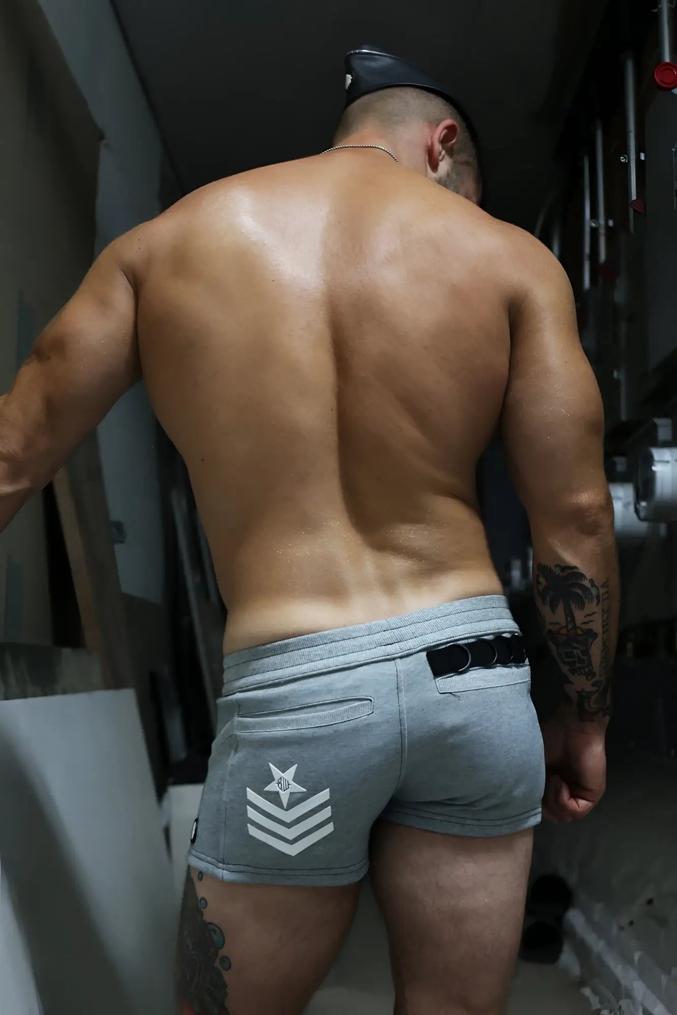 Gray cockpit shorts showing the back side with a white star and chevron insignia on the pocket