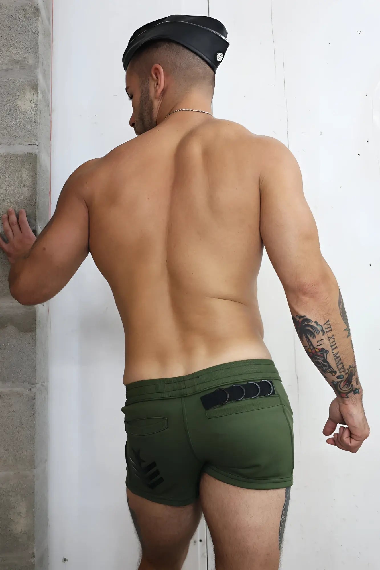 Olive green cockpit shorts with black elastic waistband and side pockets designed for athletic use