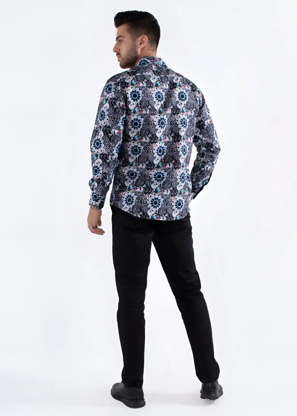A man wearing a colored shapes print long-sleeved shirt with navy white and muted blue geometric floral patterns