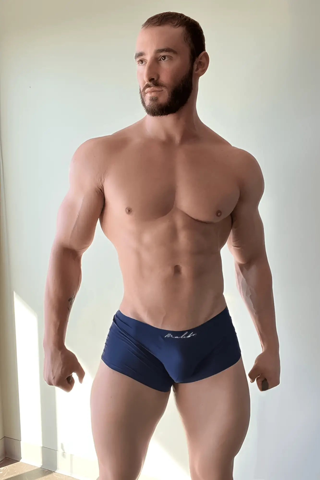 Navy blue silky seamless boxer briefs with a subtle white logo on the waistband in indigo navy color