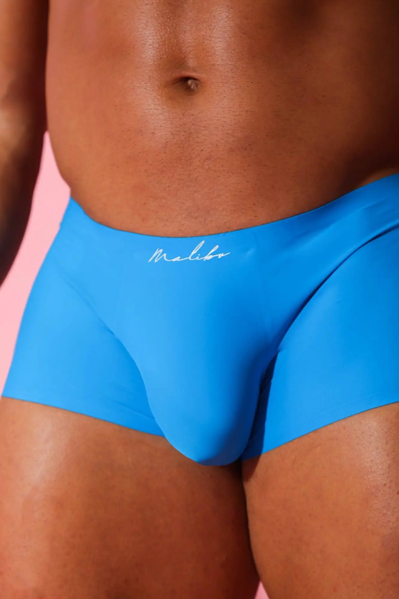 Bright blue come-over silky seamless boxer briefs with sleek form-fitting design and white cursive waistband branding