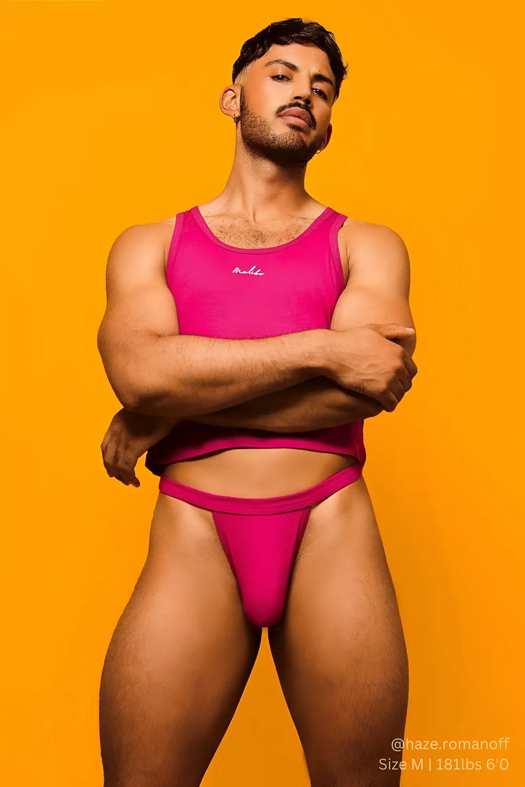 Vibrant pink athletic tank top with subtle embroidered logo on the chest for comfortable everyday wear