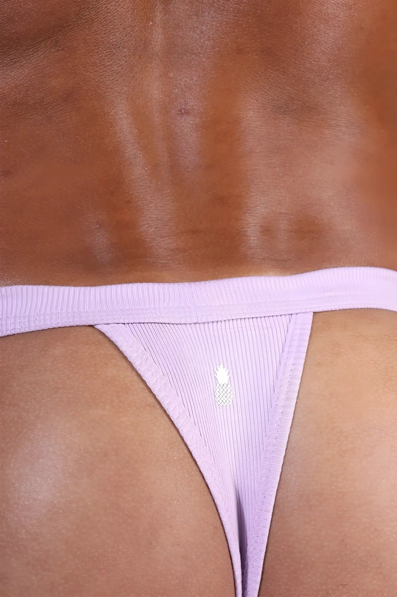 Lavender comfy everyday ribbed thong for men showing ribbed fabric and small white pineapple logo on front side