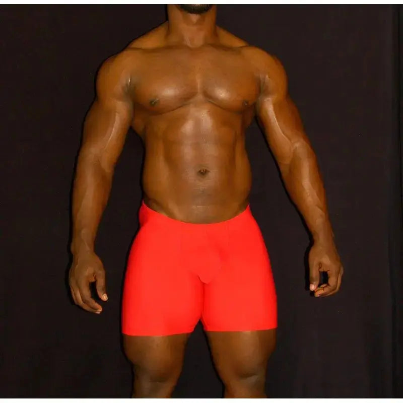 Red compression shorts by Arroyman featuring a snug fit and smooth fabric modeled by a muscular man.