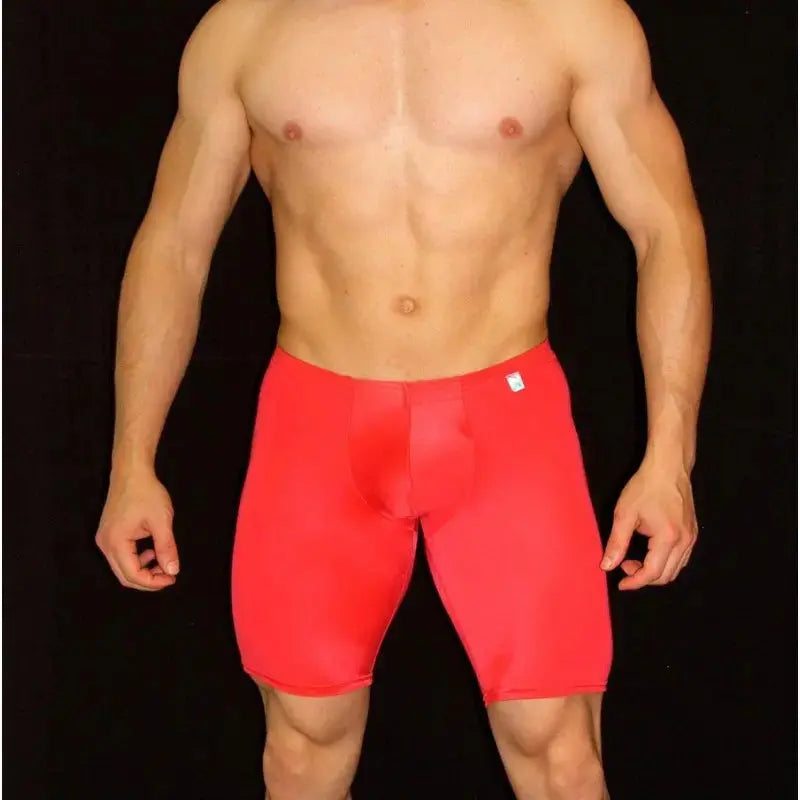 Red compression shorts made of stretchy material featuring a snug fit shown on a model by Arroyman.