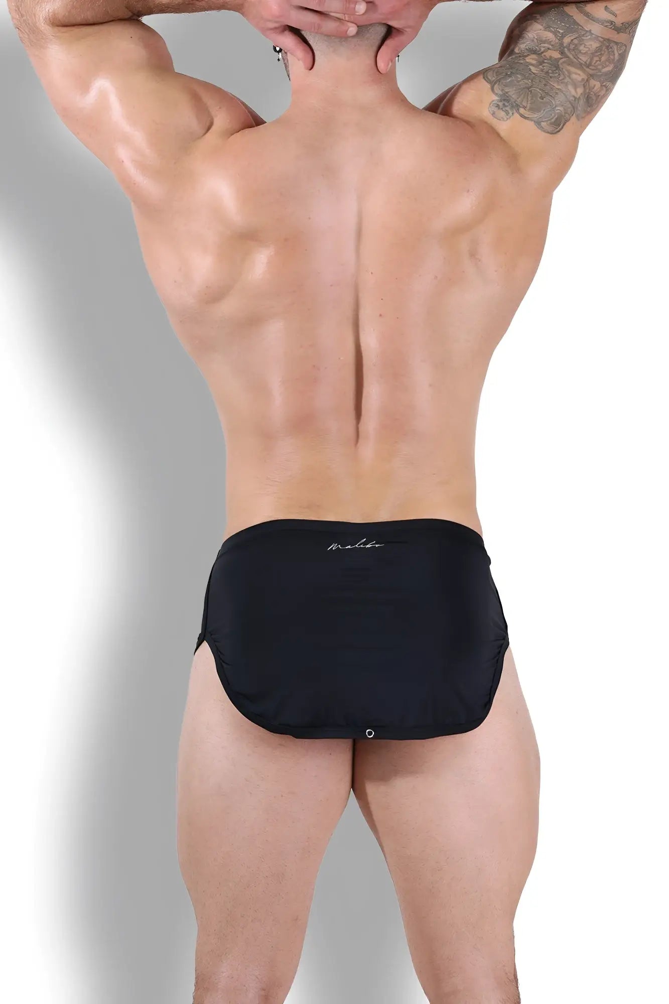 Black athletic briefs with subtle white logo on waistband part of cool-dri 2-in-1 shorts with thong lining in midnight black