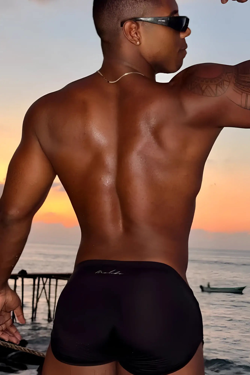 Black cool-dri 2-in-1 athletic swim trunks with thong lining and subtle white logo on the waistband