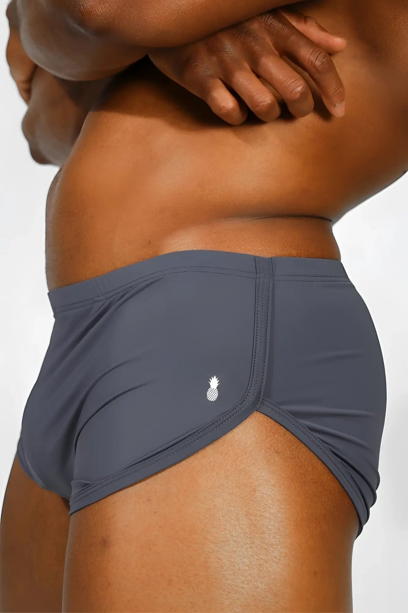 Gray athletic briefs with small white pineapple logo on side featured in cool-dri 2-in-1 space blue shorts