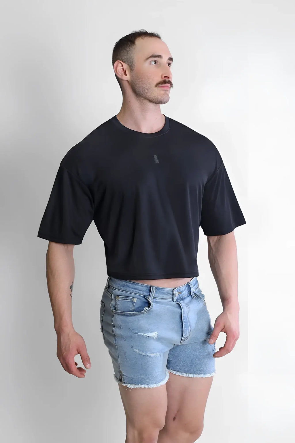 Black cool-dry oversized relaxed crop top with short sleeves and a subtle chest logo for casual wear