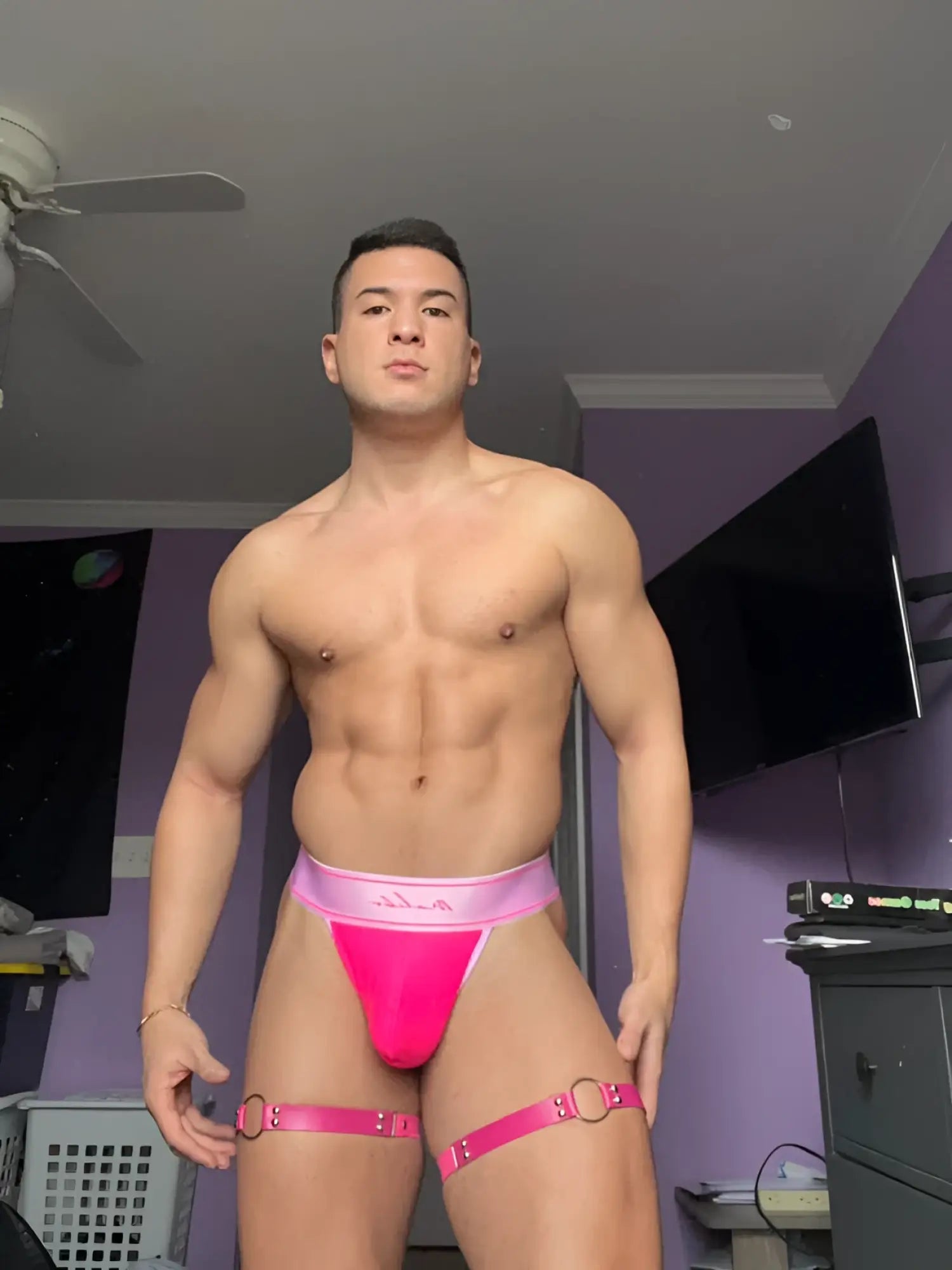 Bright pink CoolMesh Pro thong in high-waisted briefs with thigh straps and silver metal rings front view