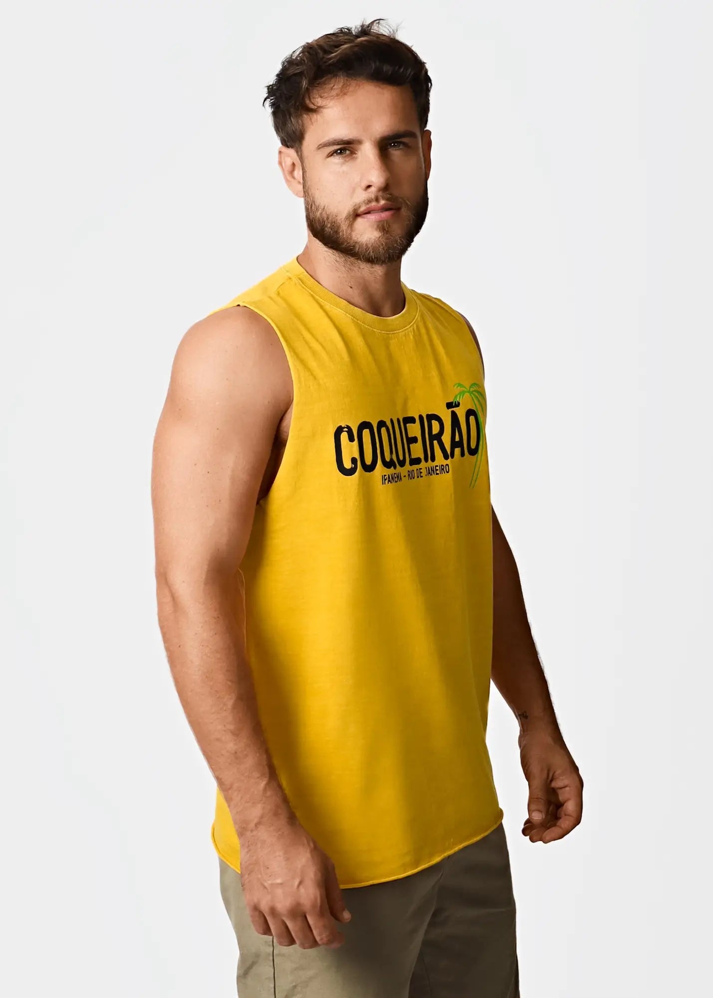 Bright yellow sleeveless men’s t-shirt with black coqueirão text and green palm tree graphic on the chest
