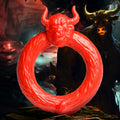 Creature Cocks Beast Mode silicone cock ring, bright red with a textured, bull-horned design against a fantasy backdrop.