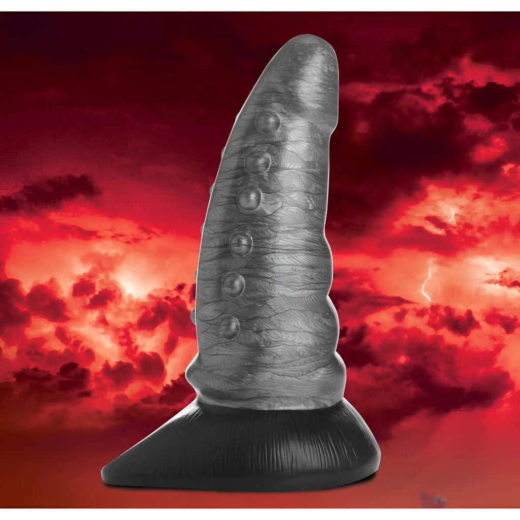 Creature Cocks Beastly silicone dildo: A grey, bumpy, tapered fantasy-style shaft on a black base against a red sky.