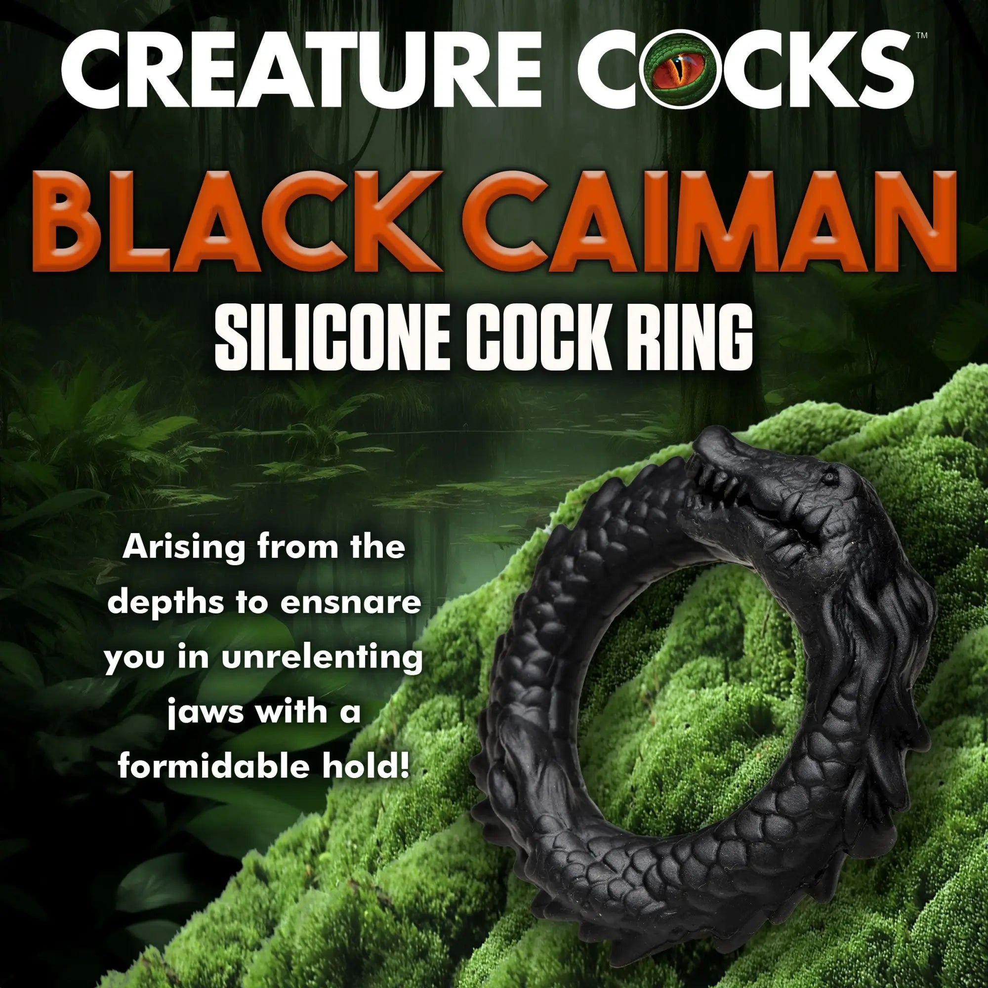 Creature Cocks Black Caiman silicone cock ring, shaped like a black alligator with textured scales on a mossy background.
