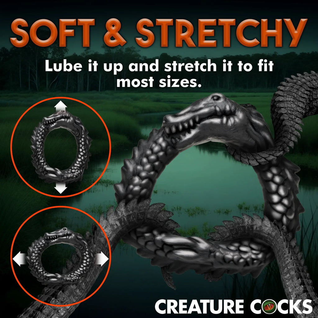 Creature Cocks Black Caiman silicone cock ring shown in a swamp background, highlighting its soft, stretchy design.
