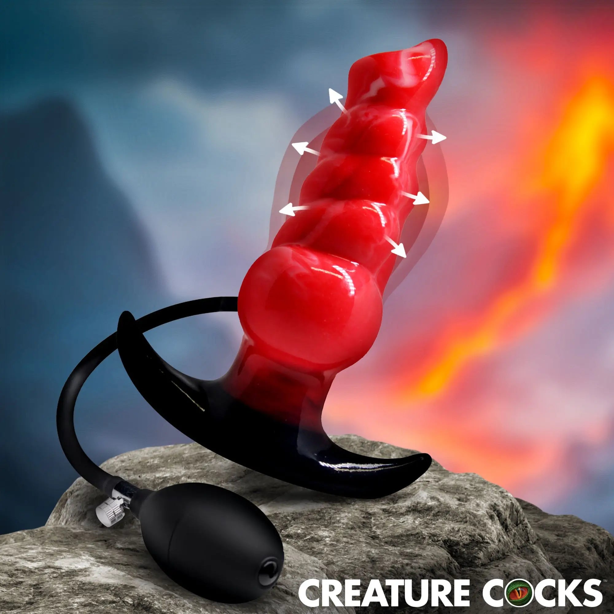 Creature Cocks Blaze inflatable red silicone anal plug with black base and pump on a rock against a fiery background.