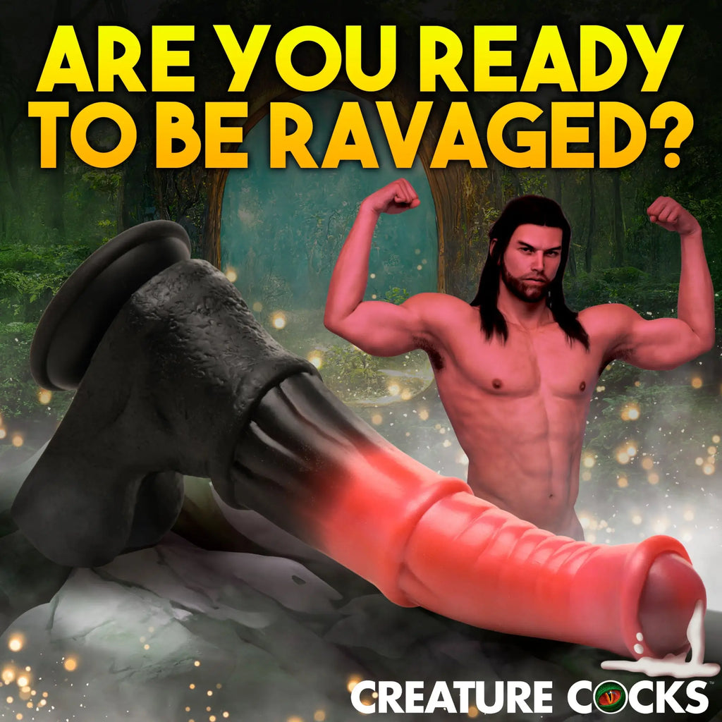 Creature Cocks Centaur Explosion dildo: a black-to-red gradient silicone toy in a fantasy forest with a muscular man.