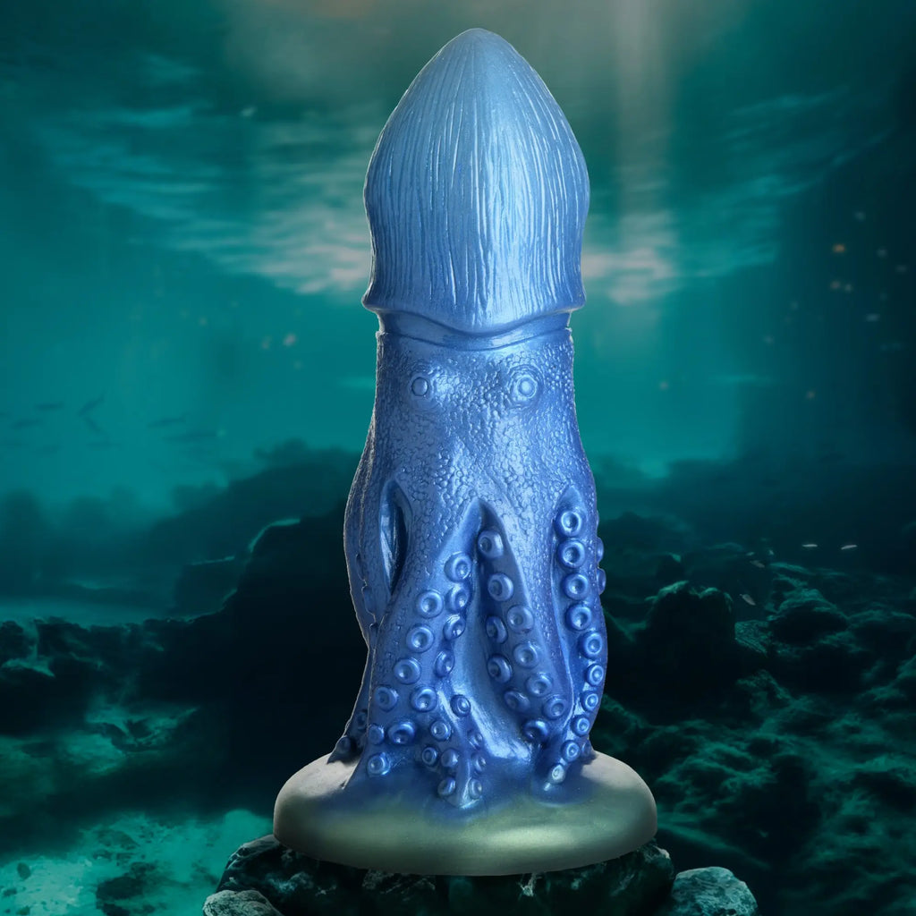 Blue Creature Cocks Cocktopus silicone dildo with octopus-inspired tentacles and suction cup base on oceanic background.