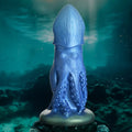 Blue Creature Cocks Cocktopus silicone dildo with octopus-inspired tentacles and suction cup base on oceanic background.