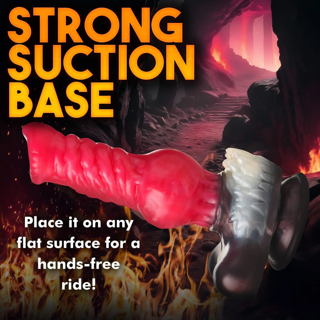 Creature Cocks Cujo Canine silicone dildo in red with white textured detail and a suction base against a fiery background.