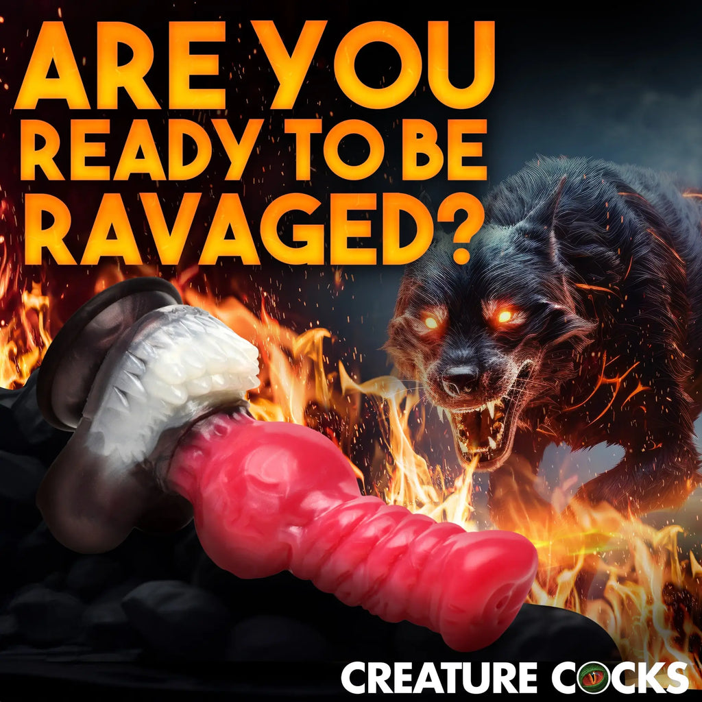 Creature Cocks Cujo silicone dildo: a red, textured canine-style toy shown against a backdrop of fire and a wolf.