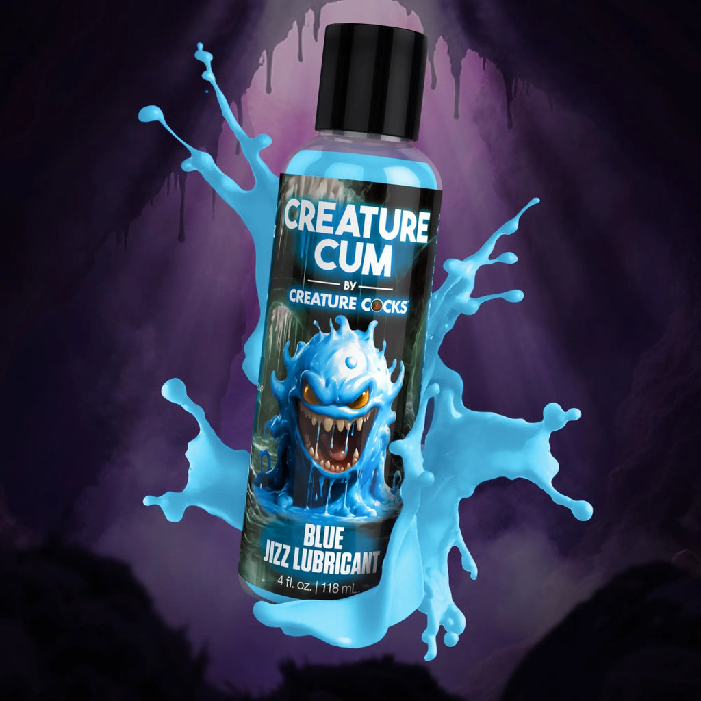 A bottle of Creature Cocks Creature Cum blue lubricant featuring a monster graphic and liquid blue splashes.