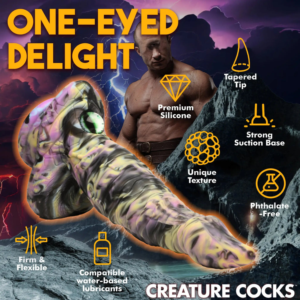 Creature Cocks Cyclops monster silicone dildo featuring a swirling purple, yellow, and black design with a glass eye.
