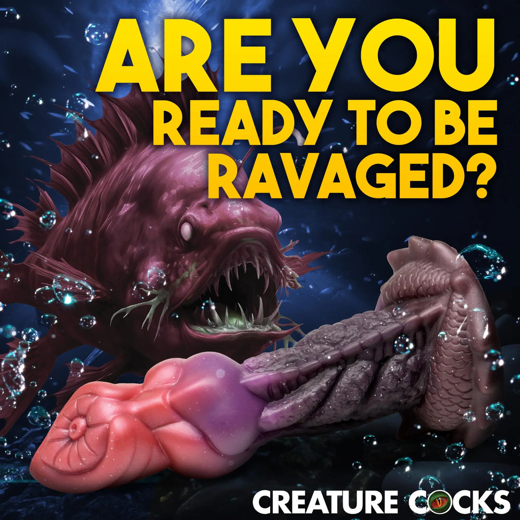 Creature Cocks Deep Diver dildo: a purple and pink, fish-textured silicone toy in an underwater scene.