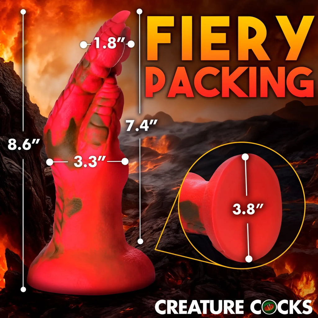 Creature Cocks Demon Claw fisting dildo in bright red with dark textured markings against a fiery volcanic background.