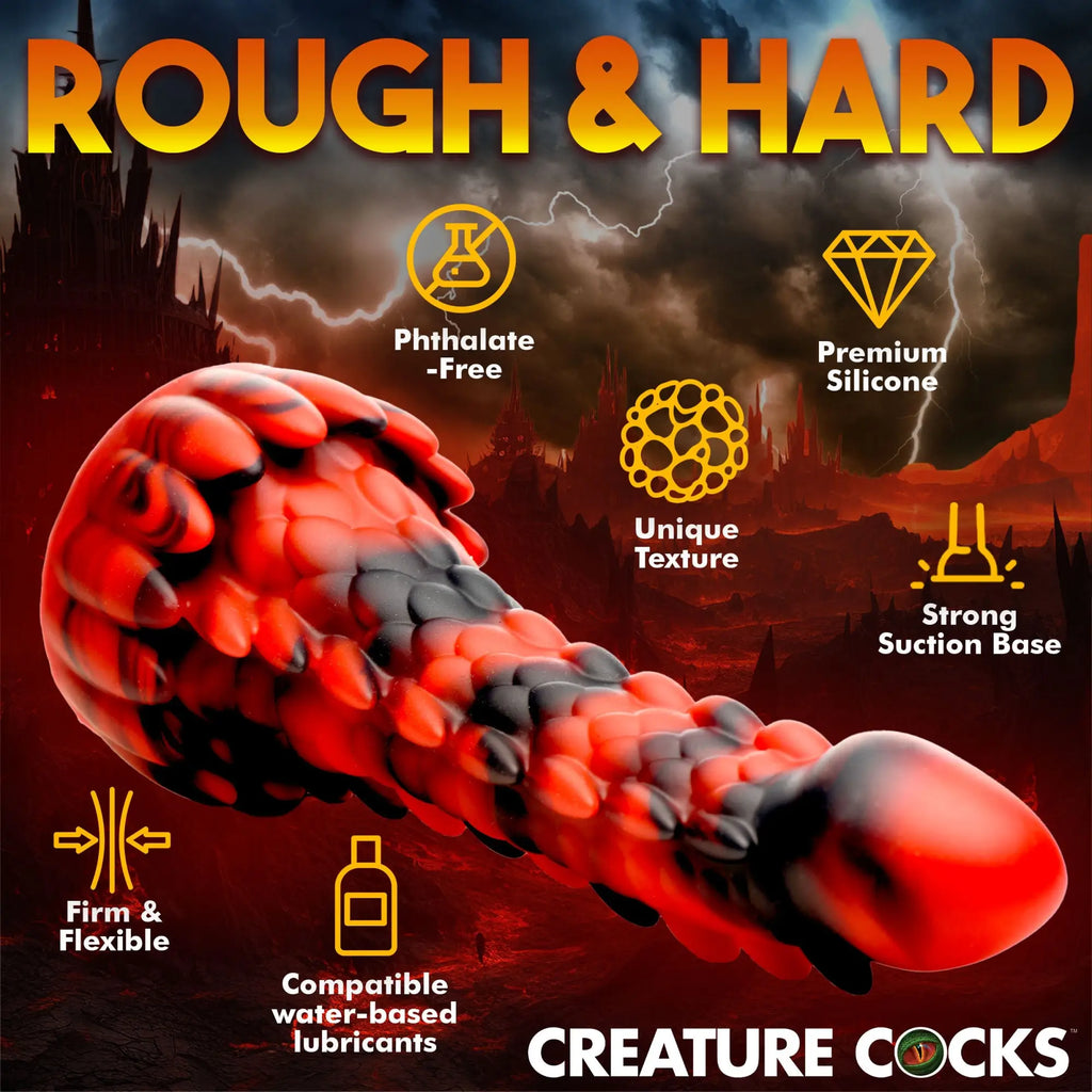 Creature Cocks Demon Rising silicone dildo in red and black with a scaly, textured dragon design against a dark storm.