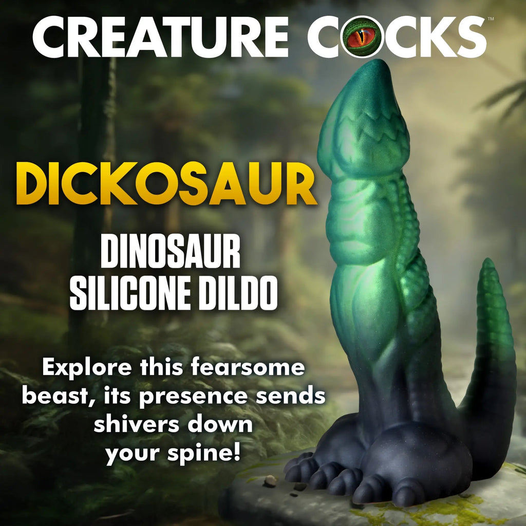 Creature Cocks Dickosaur: A textured, green and black dinosaur-themed silicone dildo standing on a forest floor.