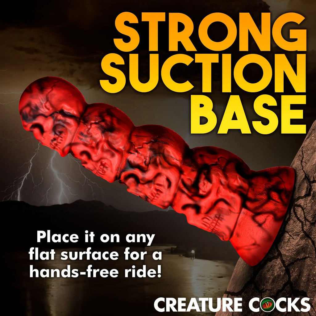 Creature Cocks Doom silicone dildo: a red, skull-textured phallic toy with a suction cup base against a stormy backdrop.