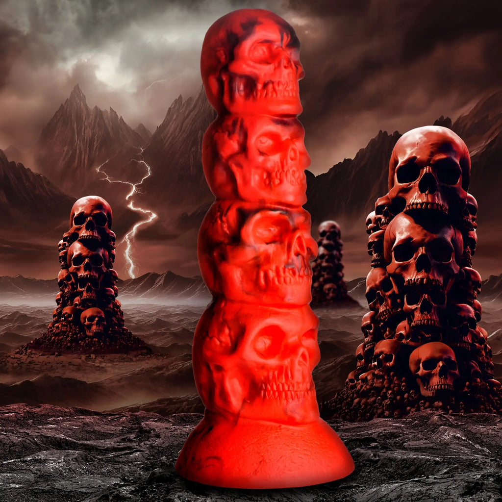 Creature Cocks Doom silicone dildo: a red, stackable skull-shaped design set against a dark, stormy mountain backdrop.